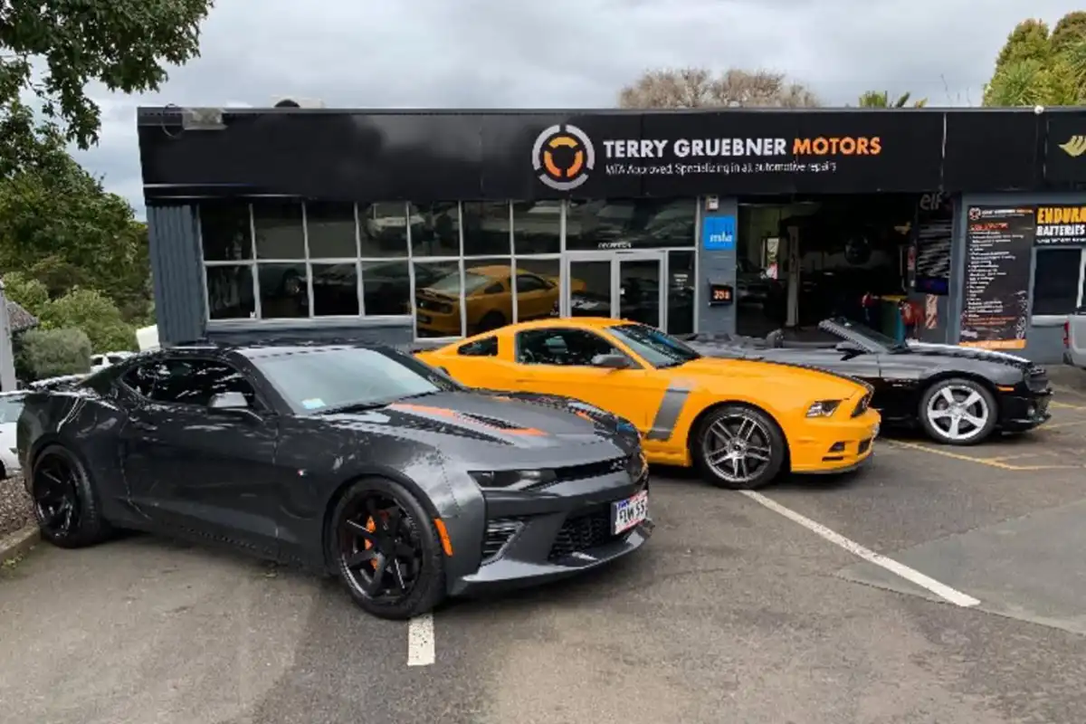muscle cars out front of TG Motors